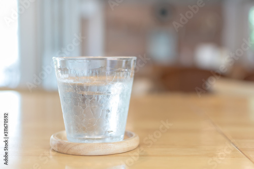Some glass of water on the wooden table in restaurant.Selective focus.