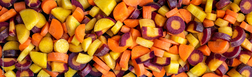 Border of diced rainbow carrots as a background