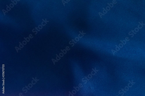 Luxury deep blue fabric background.Smooth pattern.Silk velvet material texture.Using for backdrop or wallpaper.Dark tone color.Soft focus.