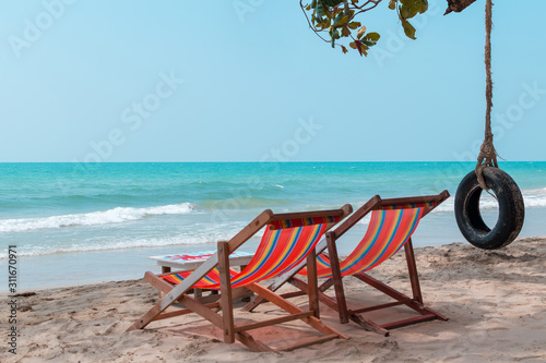 Couple beach chairs and swing with blue sky cloudless background at hawaii beach.