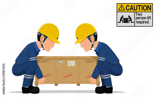 Two workers is lifting the heavy wooden crate