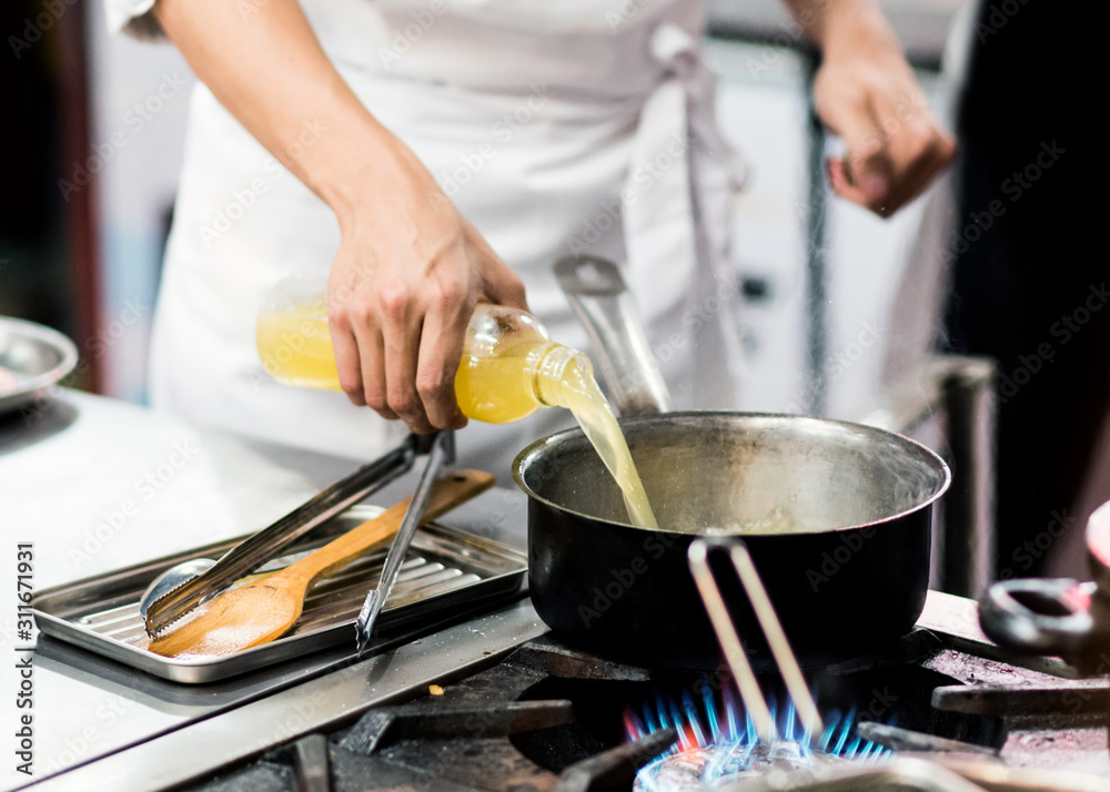 Chef cooking, Chef preparing food in the kitchen, Chef decorating dish, closeup.