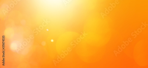 abstract orange background with bokeh lights and sunlight, panoramic background
