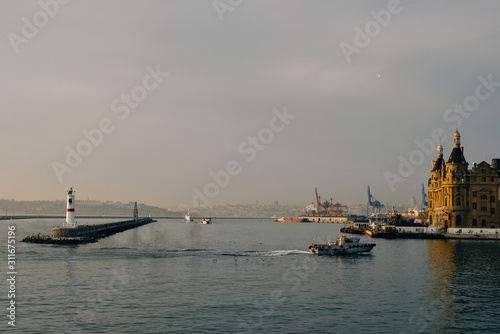 Haydarpasha port and container terminal on the Kadikoy coast in Istanbul, Turkey. Port ships boats on the water. lighthouse