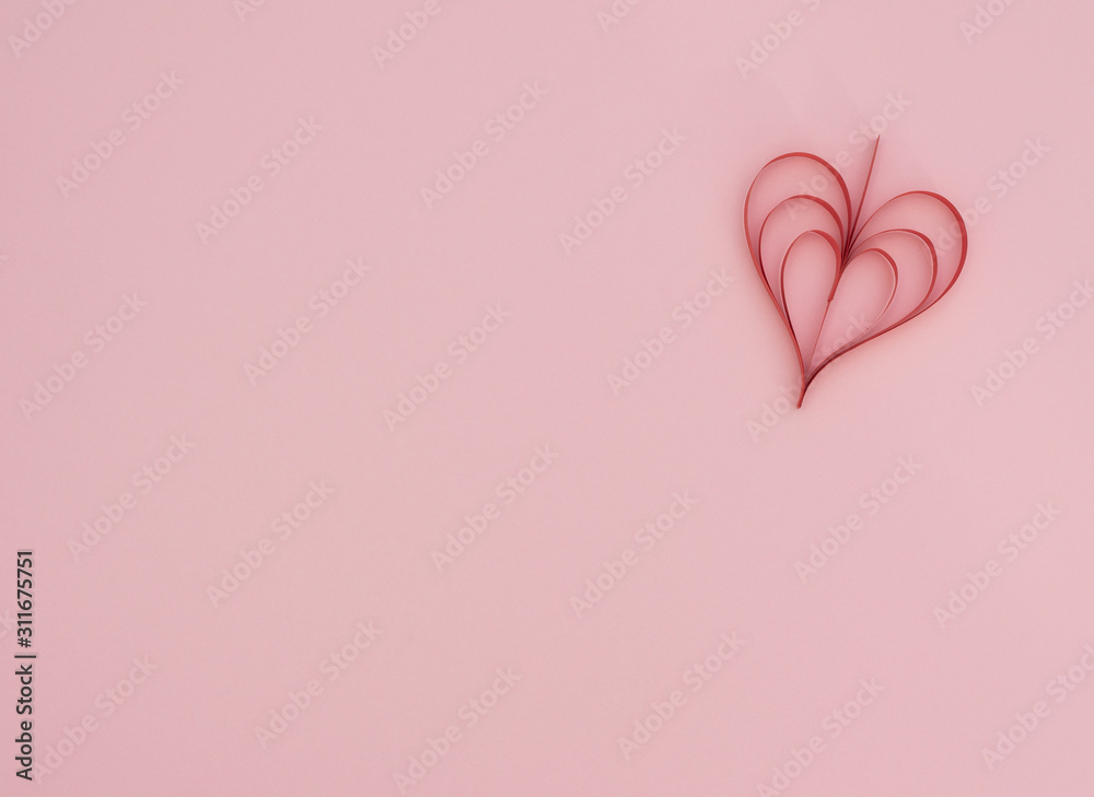 Valentine's Day pink background with handmade quilling red paper heart. Valentine greeting card. Flat lay style with copy space. Love, happiness and wedding concept.