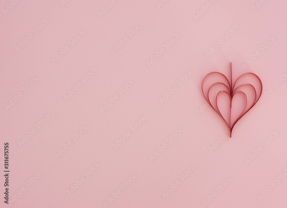 Valentine's Day pink background with handmade quilling red paper heart. Valentine greeting card. Flat lay style with copy space. Love, happiness and wedding concept.