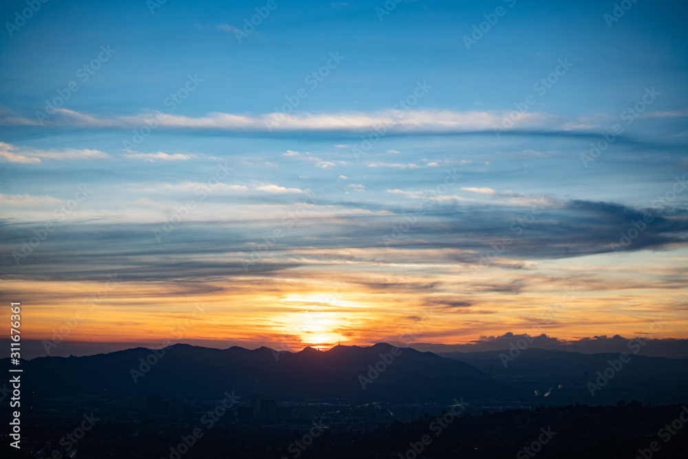 Wispy sunset of blues and oranges over Los Angeles, CA