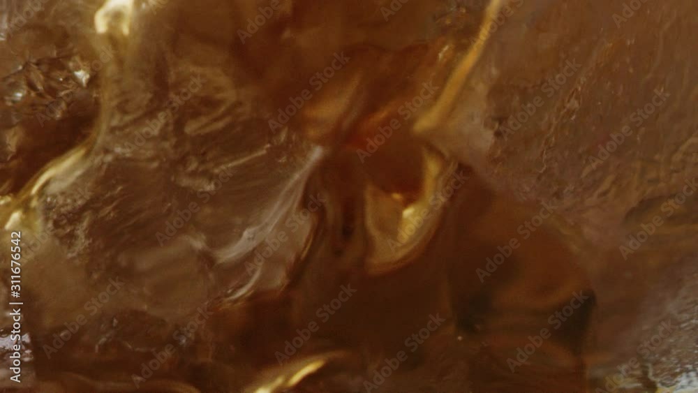Filling up cup of ice with coffee macro shot, ice drink for morning, bubbles in drink, slow motion, shot on Red Weapon Helium 8k