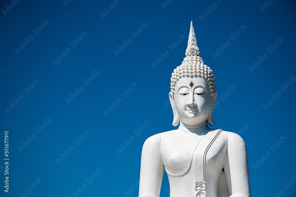 outdoor Thailand landmark beautiful buddhism architecture silver white buddha statues antique meditation in temple have copy space and blue sky background.