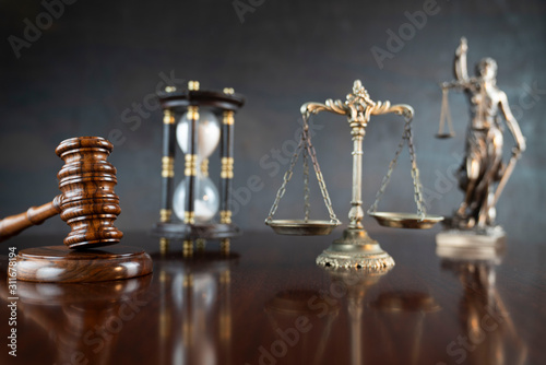 Law theme. Gavel of the judge, Themis statue and scale of justice on gray background.