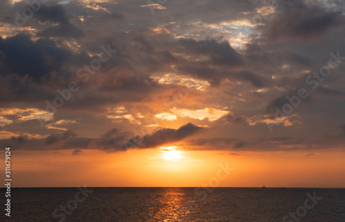  sunset time and clouds above the seascape