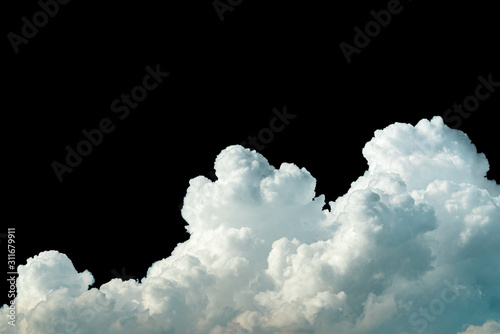 Pure white cumulus clouds on black background. Cloudscape background. White fluffy clouds on dark background. Soft cotton feel of white clouds texture isolated on black background with copy space
