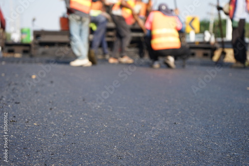 Construction workers on the asphalt road, blurred pictures