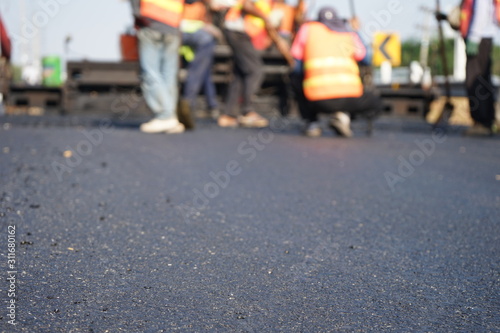 Wallpaper Mural Construction workers on the asphalt road, blurred pictures Torontodigital.ca