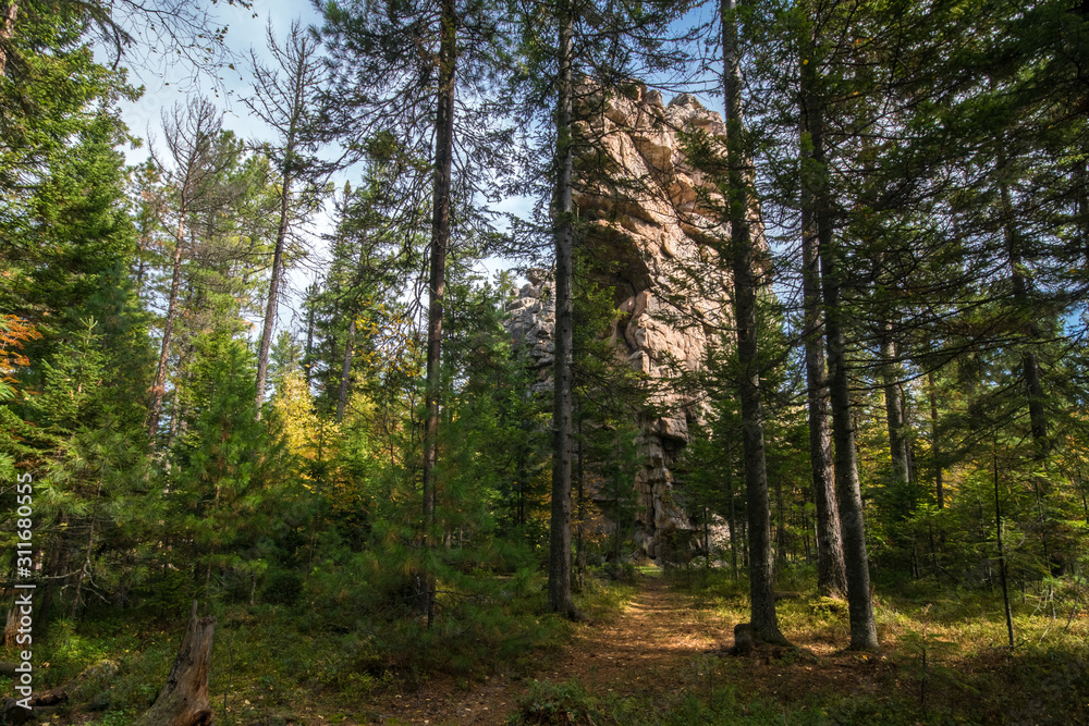 Rock in the autumn forest on the Olkha plateau Rock in the autumn forest on the Olkha plateau