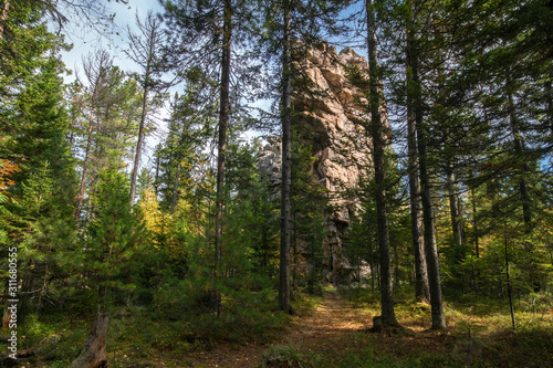 Rock in the autumn forest on the Olkha plateau