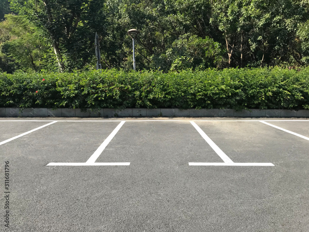 Empty outdoor parking space. Car parking lot with white lines mark. Photos  | Adobe Stock
