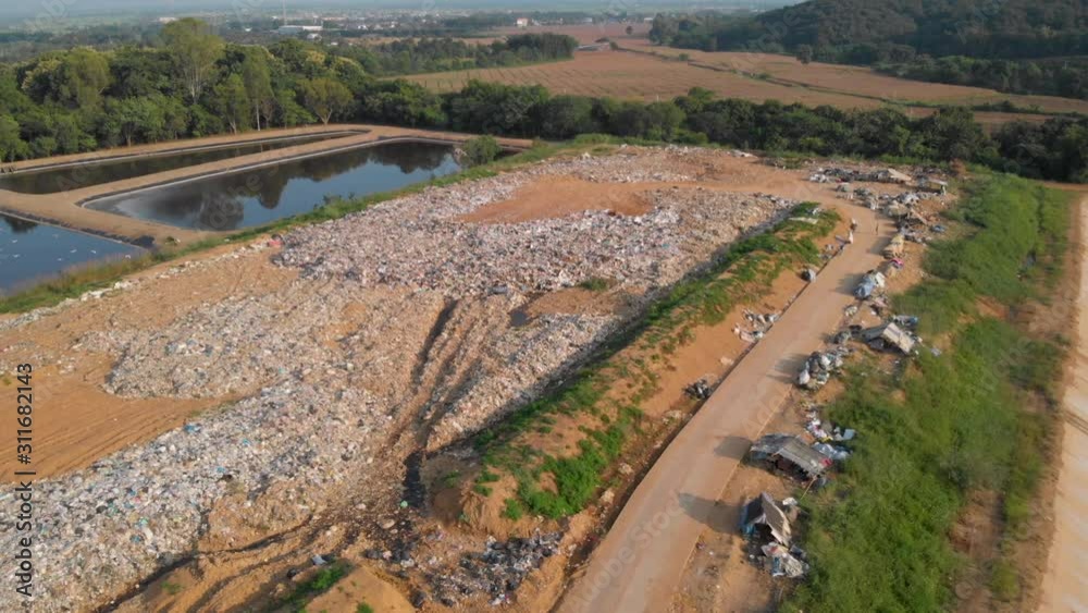 4k dump land. Wastes rubbish. Aerial View, slowly descent , dispose trash on the landfill, day time small lake, bird fly, social issues, global warming, conservation, recycle. foods 4k dump land. Wastes rubbish. Aerial View, slowly descent , dispose trash on the landfill, day time small lake, bird fly, social issues, global warming, conservation, recycle. foods