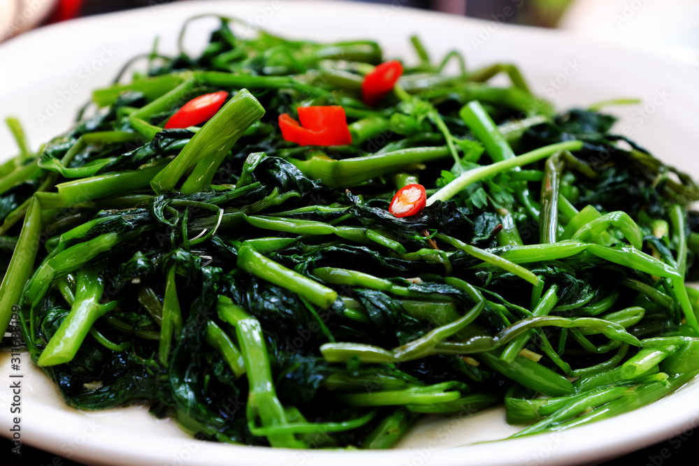 Simple vegan food for vegetarian meal, water spinach fry with cooking oil Simple vegan food for vegetarian meal, water spinach fry with cooking oil