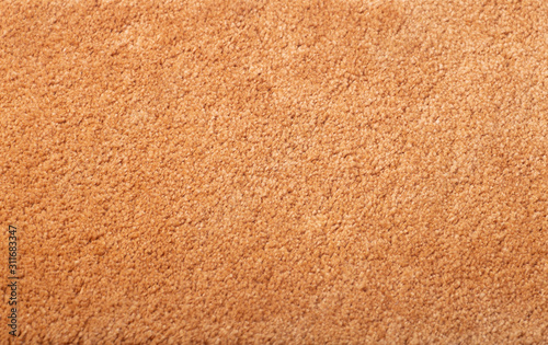Carpet covering background. Pattern and texture of peach colour carpet. Copy space.
