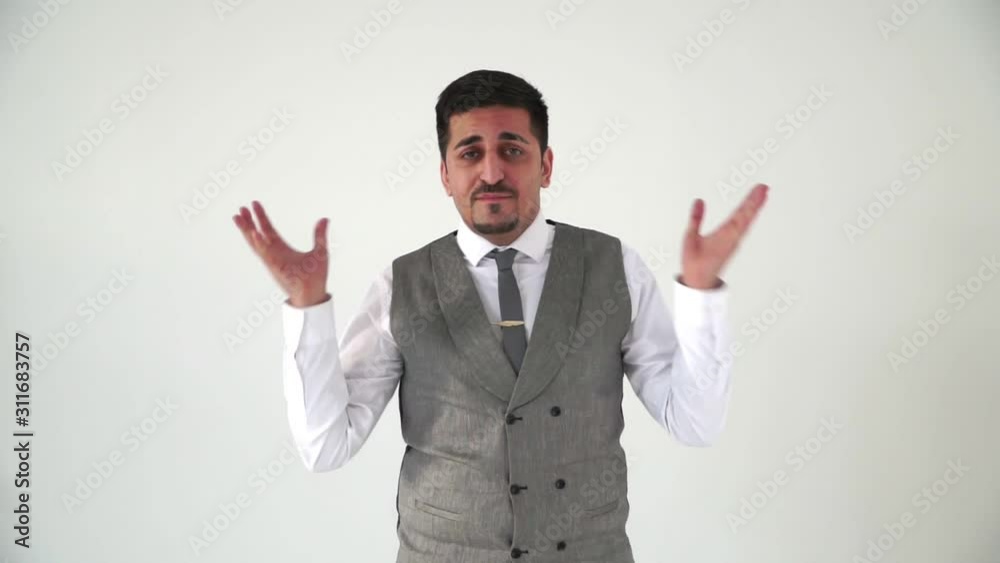 The Oriental man raises his hands in the air and shakes his head disapprovingly