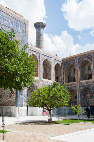 View of the ancient madrasah on a clear sunny day photo