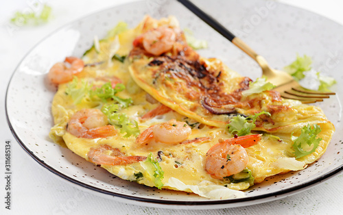 Breakfast. Ketogenic/paleo diet. Omelet with shrimp and herbs. Keto menu. Omelette.