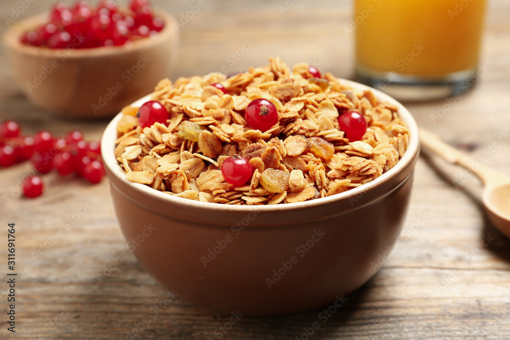 Muesli with berries served on wooden table. Delicious breakfast Muesli with berries served on wooden table. Delicious breakfast
