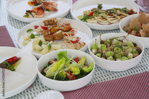 Various healthy fish and vegetables meals served on the table, healthy summer lunch 