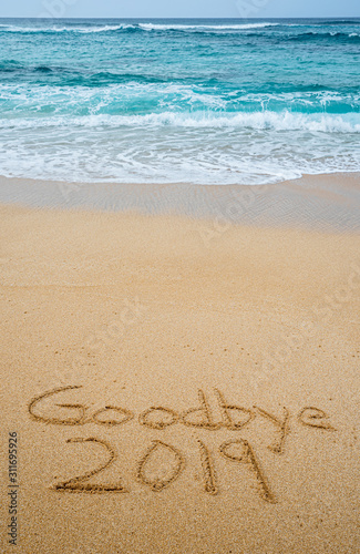 Goodbye 2019 written in the sand- New Year’s concept