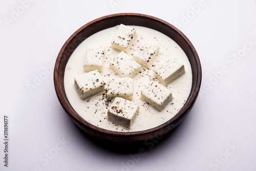 Paneer Dum Kali Mirch / Kalimirch, prepared in a white creamy gravy and black pepper powder sprinkled over it. served in a bowl. Selective focus photo