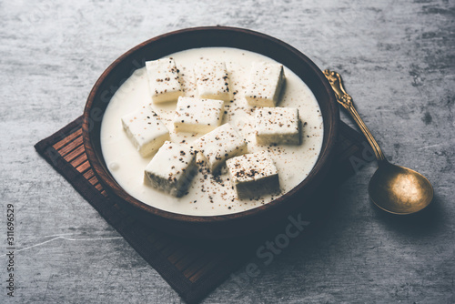 Paneer Dum Kali Mirch / Kalimirch, prepared in a white creamy gravy and black pepper powder sprinkled over it. served in a bowl. Selective focus photo