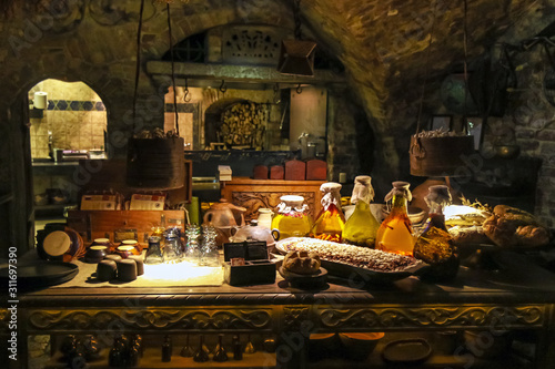 rich table with lots of food in a medieval style in the basement