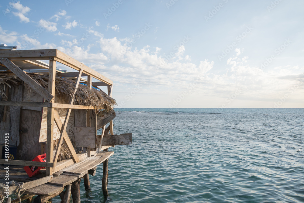 On the left a glimpse of the famous Pelican Bar, Jamaica. On the right the caribbean sea and the sky
