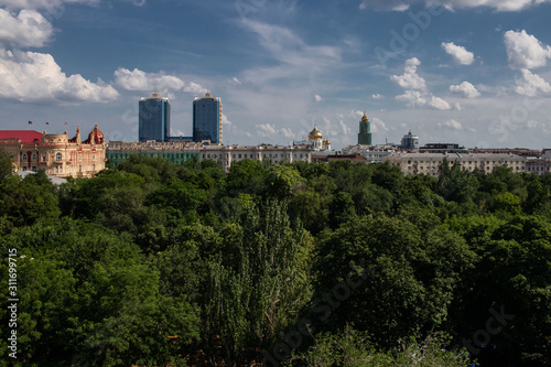 view of an old building, 2 skyscrapers and a church in the background