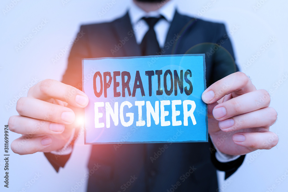 Writing note showing Operations Engineer. Business concept for analyze and design operation that will improve work flow Male human wear formal work suit with office look hold book Writing note showing Operations Engineer. Business concept for analyze and design operation that will improve work flow Male human wear formal work suit with office look hold book