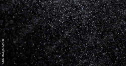 Natural white winter snowfall on a black background