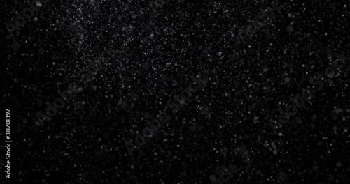 Natural white winter snowfall on a black background