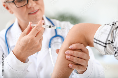 Mature doctor giving young ...