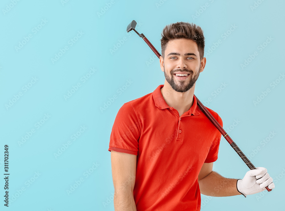 Handsome male golfer on color background Handsome male golfer on color background