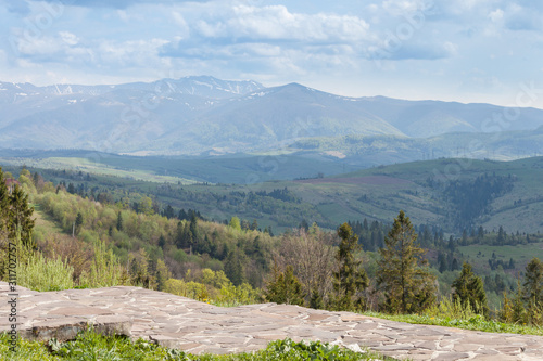 Amazing scenic mountain landscape in spring with snow on tops. Carpathians, Ukraine.