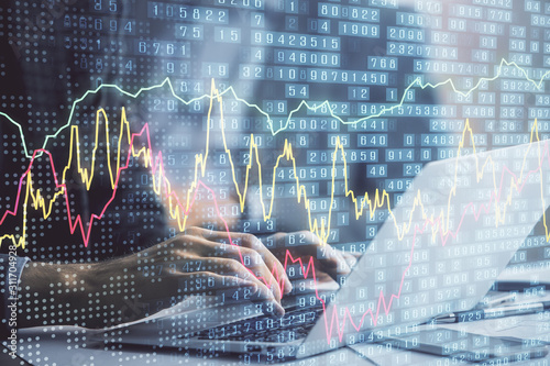 Double exposure of market chart with man working on computer on background. Concept of financial analysis.