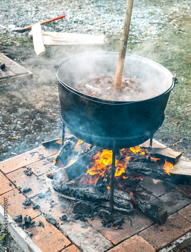 Romanian traditional food prepared at the cauldron on the open fire with wood, Christmas tradition photo