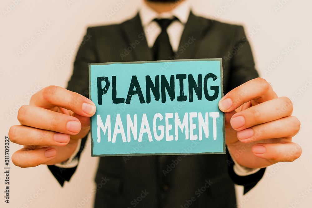 Writing note showing Planning Management. Business concept for act or process of making or carrying out plans Male human wear formal work suit with office look hold book Writing note showing Planning Management. Business concept for act or process of making or carrying out plans Male human wear formal work suit with office look hold book