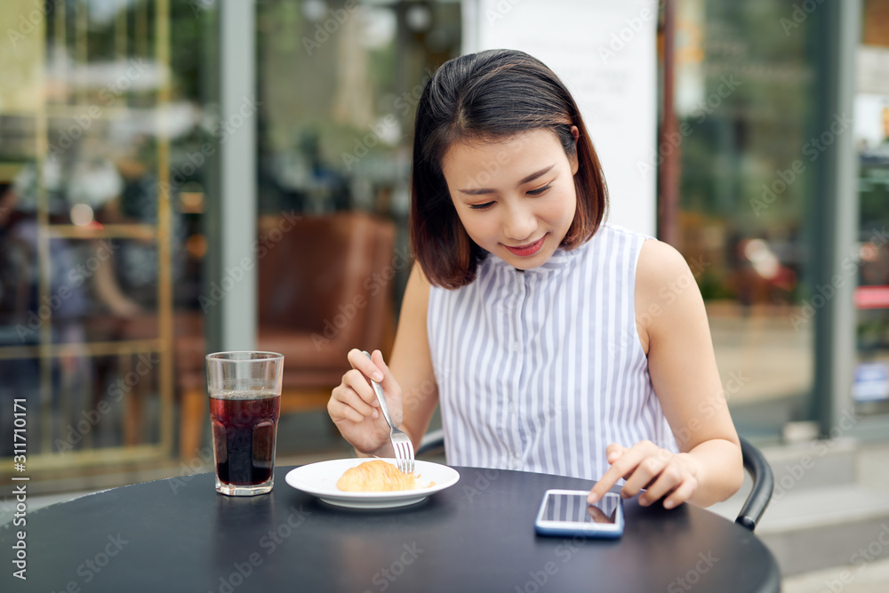 Asian woman using smartphone in coffee shop cafe Asian woman using smartphone in coffee shop cafe