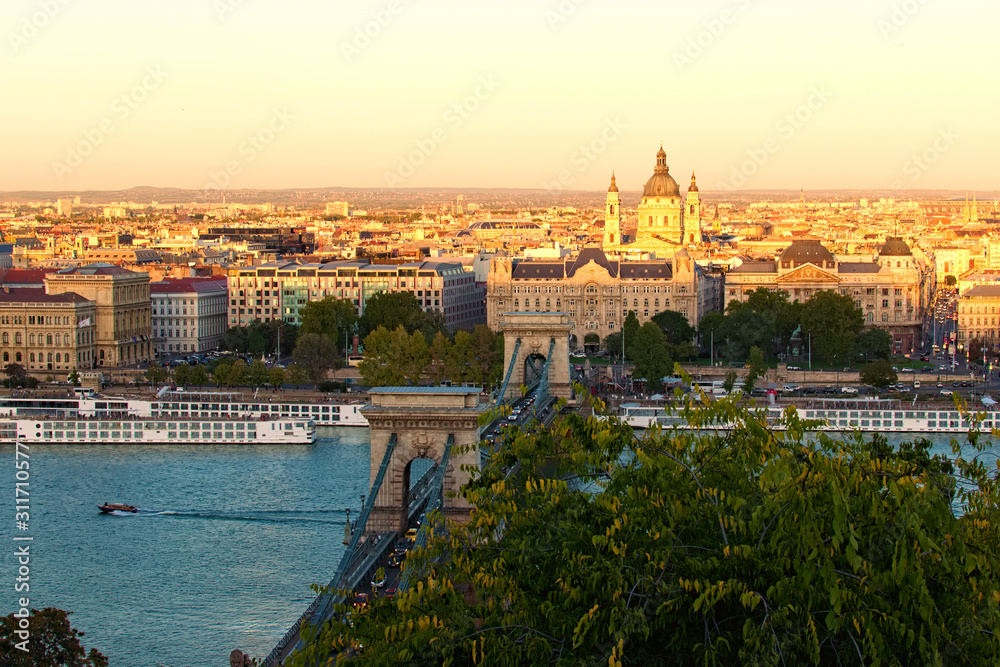 Scenic autumn landscape view of Budapest. Ancient Chain Bridge over Danube River. Sunset in the city. Medieval buildings along the embankment of the river. Travel and tourism concept. Budapest,Hungary