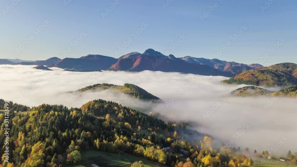 Aerial hyper lapse of foggy autumn mountains landscape in alpine nature at sunny morning Time lapse