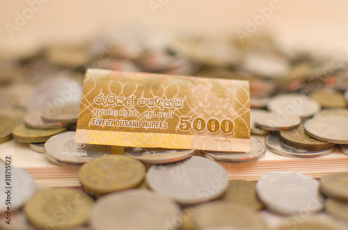 Money Sri Lankan  five thousand thousand ruppee bill and asorted coins isolated on white background photo