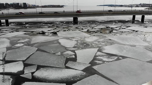 Broken ice on sea in Helsinki, shot with drone between Ruoholahti and Lauttasaari photo