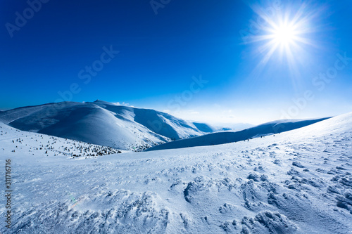 Landscape of snow winter valley and mountains on sunny day